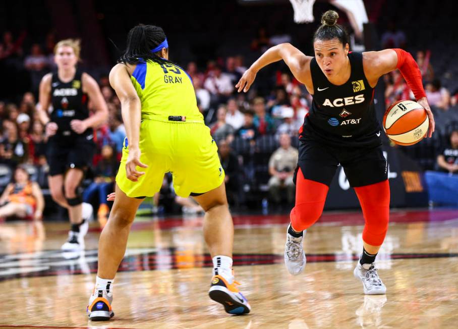 Las Vegas Aces' Kayla McBride drives to the basket against Dallas Wings' Allisha Gray (15) duri ...