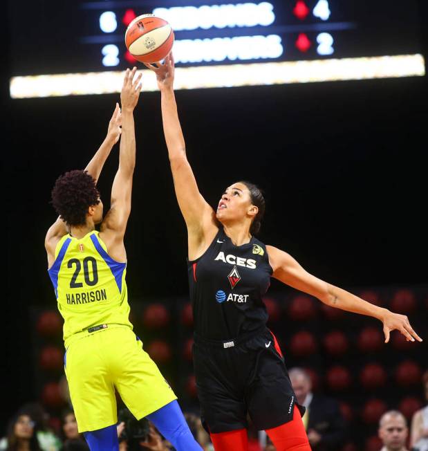 Las Vegas Aces' Liz Cambage blocks a shot from Dallas Wings' Isabelle Harrison (20) during the ...