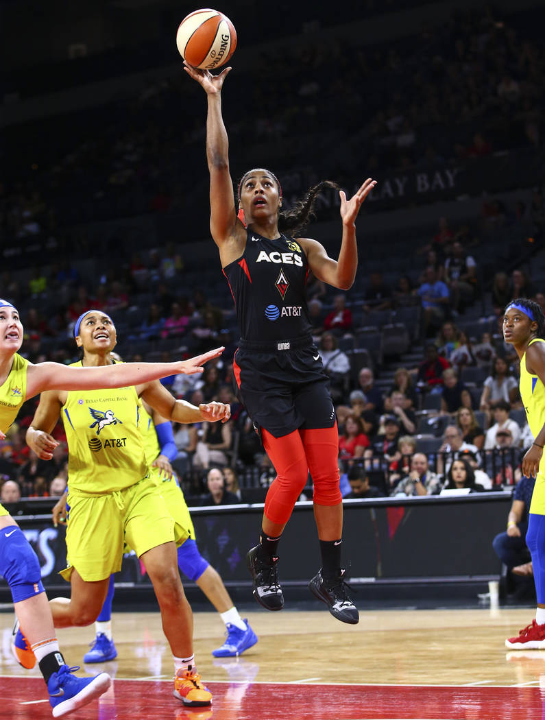 Las Vegas Aces' Sydney Colson shoots against the Dallas Wings during the first half of a WNBA b ...