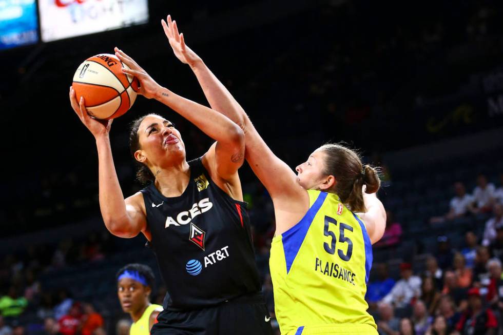 Las Vegas Aces' Liz Cambage shoots around Dallas Wings' Theresa Plaisance (55) during the first ...