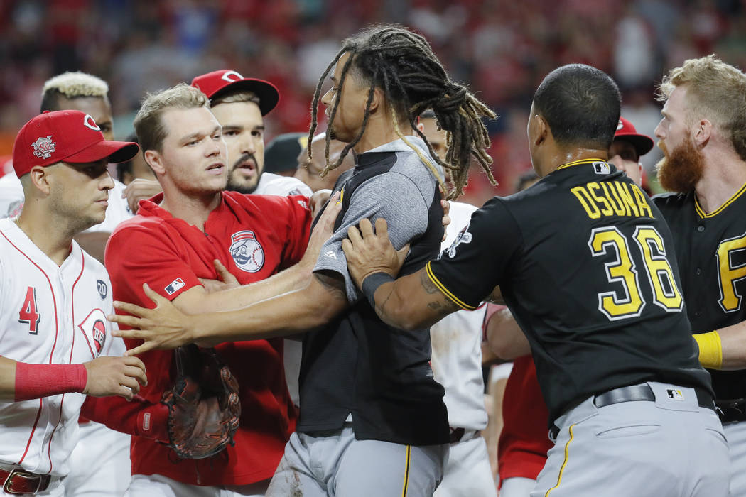 Pittsburgh Pirates starting pitcher Chris Archer, center is restrained during a bench-clearing ...