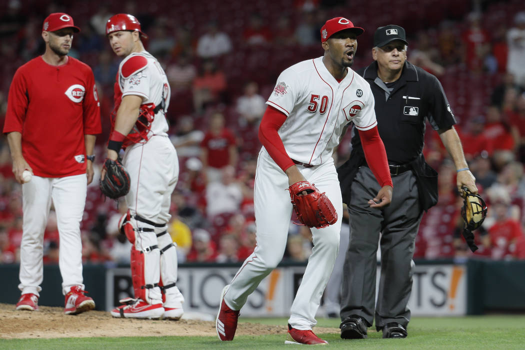 Cincinnati Reds relief pitcher Amir Garrett (50) charges the Pittsburgh Pirates bench in the ni ...