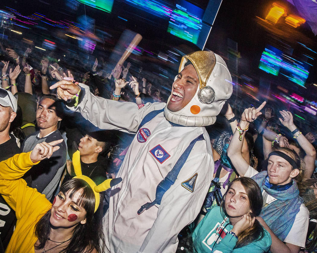 Victor Aballai, middle, and Maria Cunvi, left, dance during Steve Aoki's performance at the Cir ...