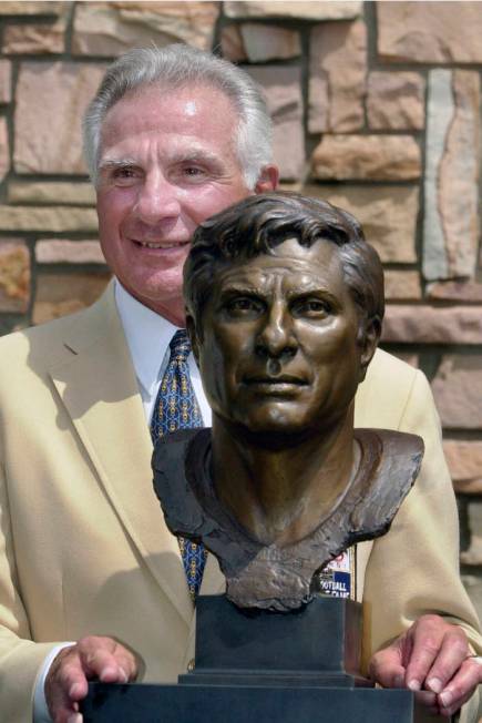 FILE - In this Aug. 4, 2001, file photo, former Miami Dolphins great Nick Buoniconti holds his ...