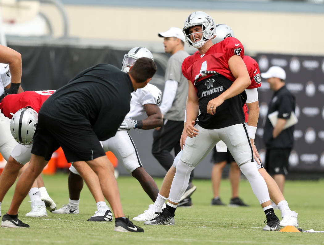 Oakland Raiders quarterback Derek Carr (4) warms up during the NFL team's training camp in Napa ...