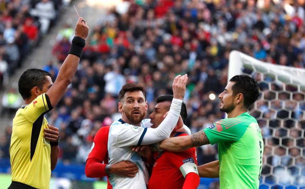 Argentina's Lionel Messi, center left, and Chile's Gary Medel, center right, scuffle as referee ...