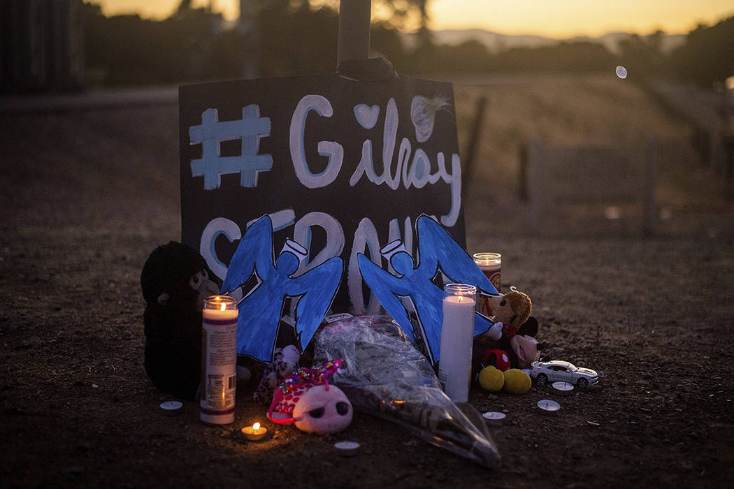 Candles burn at a makeshift memorial for Gilroy Garlic Festival shooting victims outside the fe ...