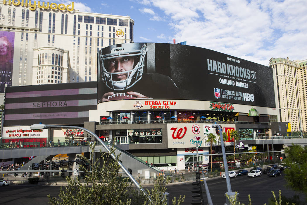 A digital billboard displays Oakland Raiders' Derek Carr in an advertisement for the upcoming s ...