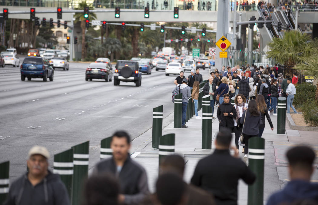 People walk past recently installed safety bollard on the Vegas Strip on Tuesday, Jan. 2, 2018. ...