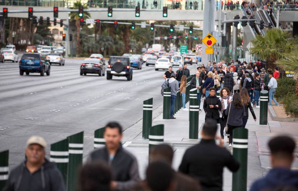 People walk past recently installed safety bollard on the Vegas Strip on Tuesday, Jan. 2, 2018. ...