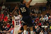 Canyon Springs guard Jordan Davis soars to the basket past Valley guard Nick Brannon in the ...