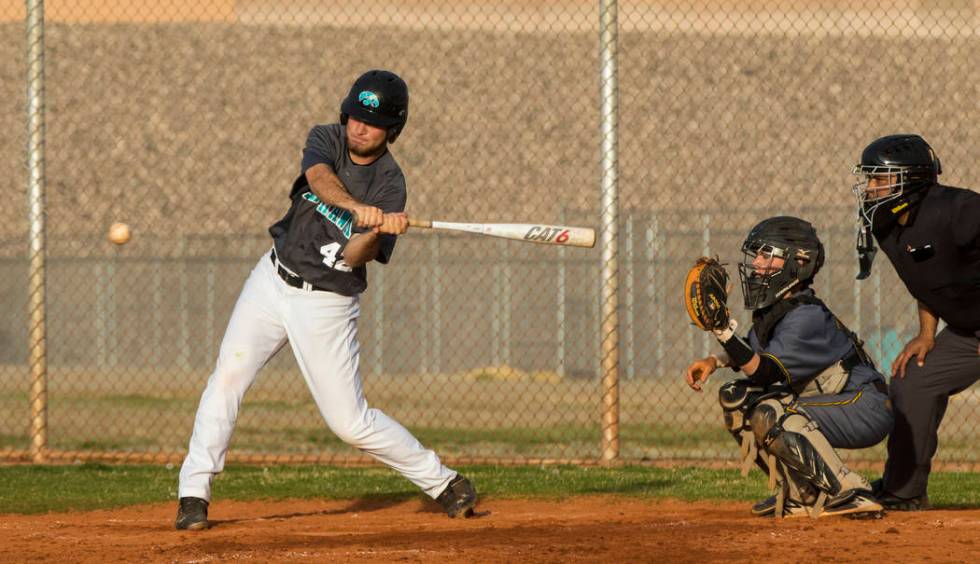 Silverado first baseman Michael Janosik (42) hits the ball in the fifth inning during a base ...