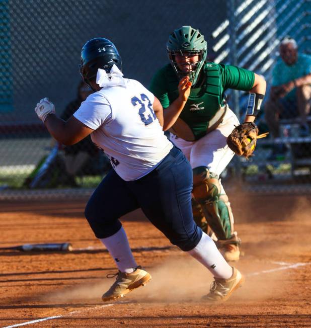 Shadow Ridge first baseman Alyssa Stanley (22) is tagged out while running back to third bas ...