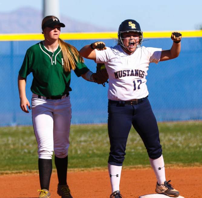 Shadow Ridge shortstop Alisha Schultz (17) celebrates at second base after hitting a double ...