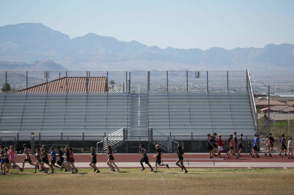 Track and field teammates warm up during a practice at Coronado High School on Tuesday, Marc ...