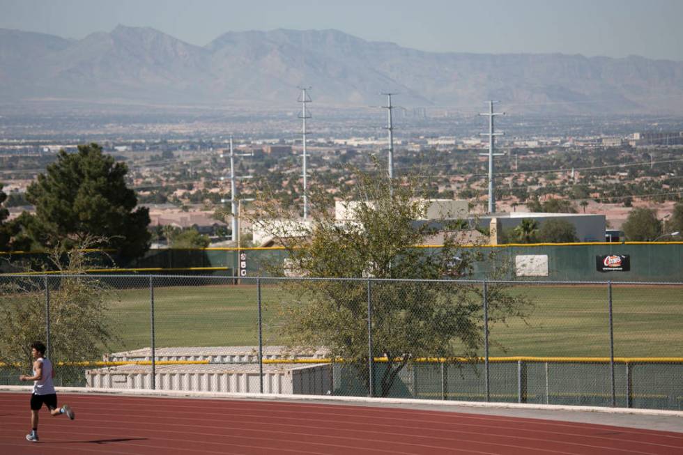 Edward &quot;Teddy&quot; Andrews warms up prior to pole vaulting during a track and ...