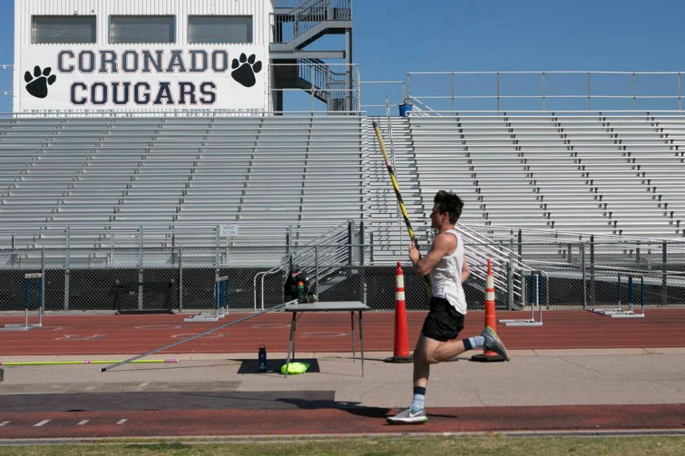 Edward &quot;Teddy&quot; Andrews does warmup runs prior to pole vaulting during a tr ...