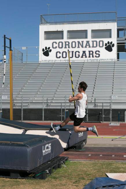 Edward &quot;Teddy&quot; Andrews practices pole vaulting during a track and field pr ...