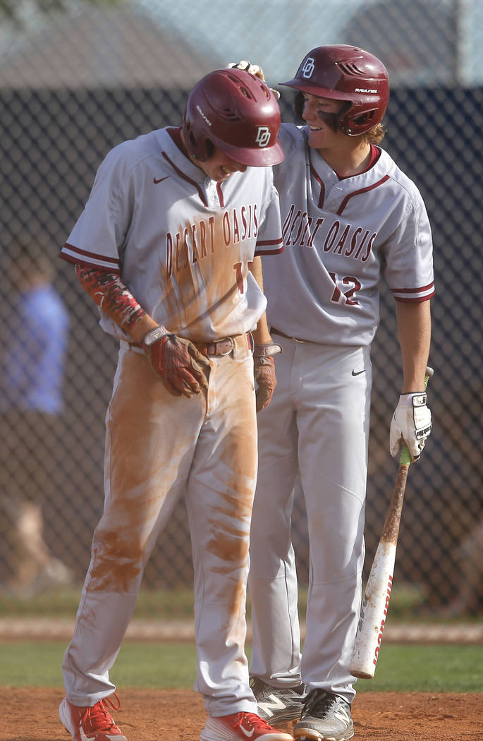 Desert Oasis’s Jason Sharman (12) congratulates Desert Oasis’s Brett Brocoff (11 ...