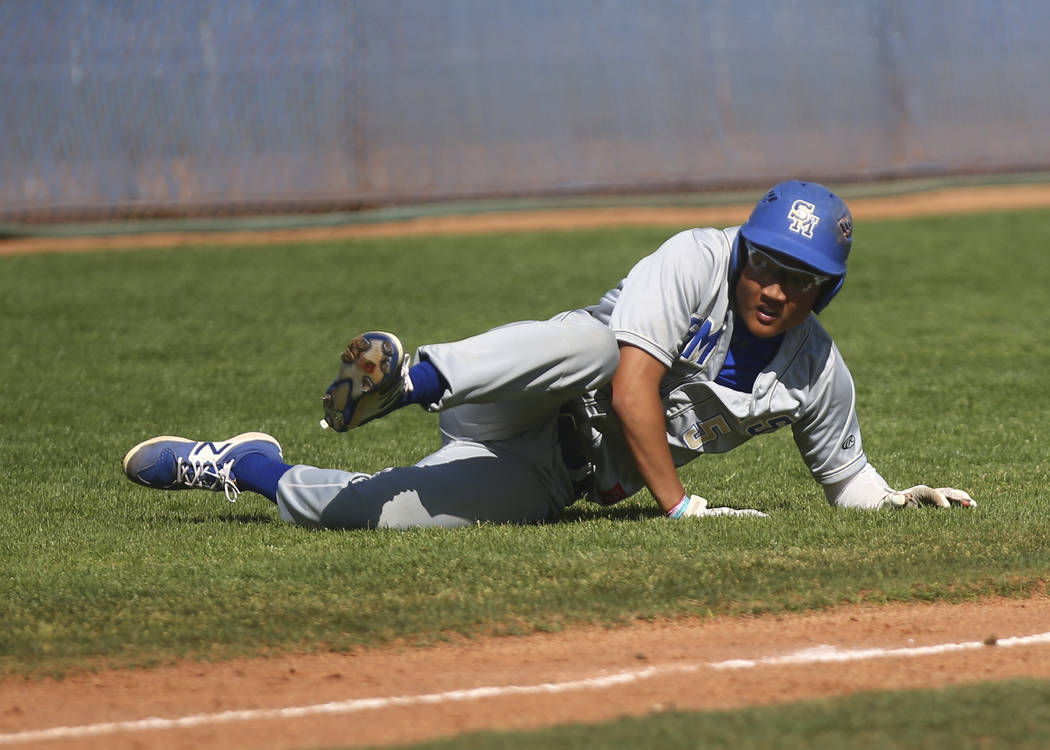 Santa Margarita’s Derek Park (5) trips up before getting tagged out by Basic during a ...