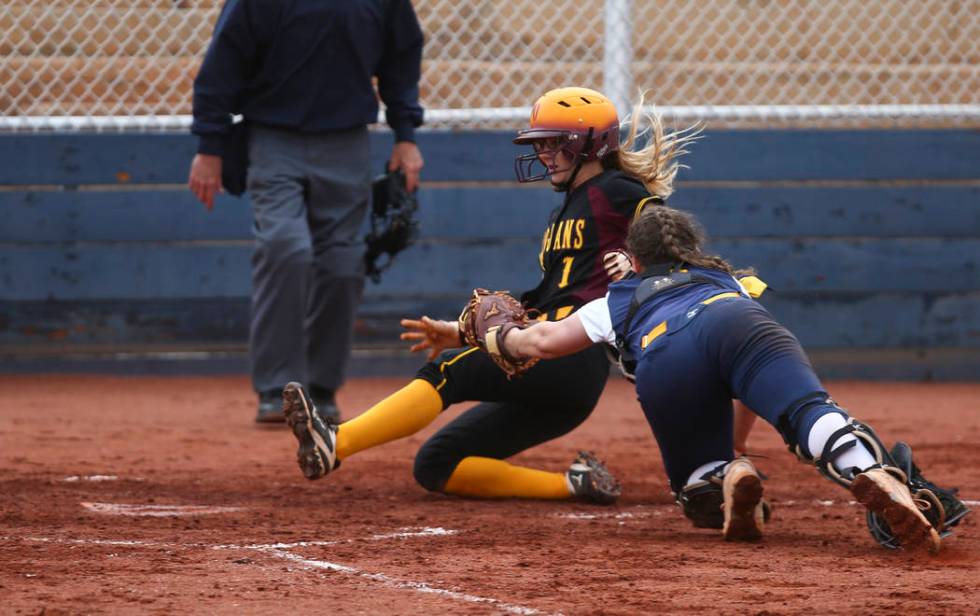 Pahrump’s Terrena Martin (1) slides past Boulder City’s Marleena Mills (6) to sc ...