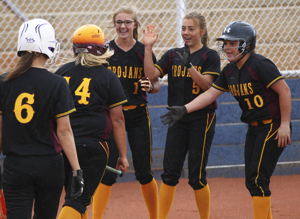 Pahrump’s Jordan Egan (14) is congratulated on her home run by Terrena Martin (1), Sky ...