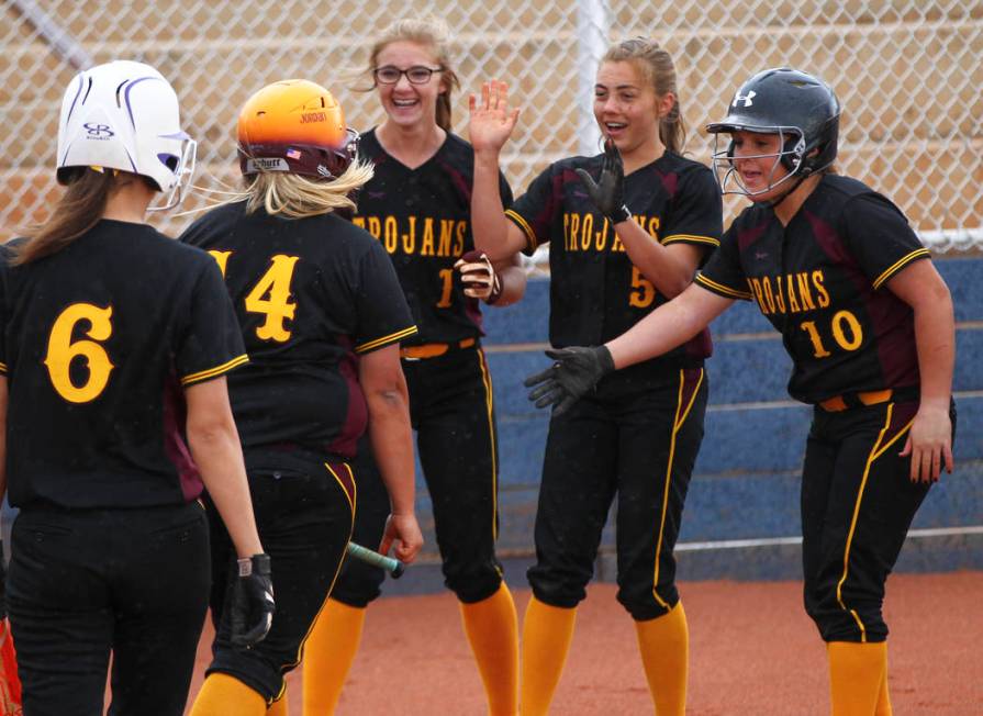 Pahrump’s Jordan Egan (14) is congratulated on her home run by Terrena Martin (1), Sky ...