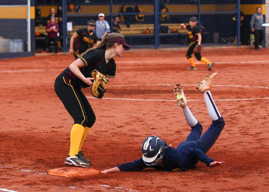 Pahrump’s Jill Smith (8) tags out Boulder City’s Ellie Ramsey (3) at first base ...