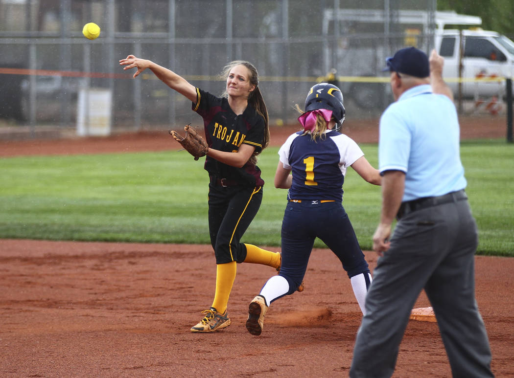 Pahrump’s Jackie Stobbe (13) throws to first base after tagging out Boulder City&#8217 ...