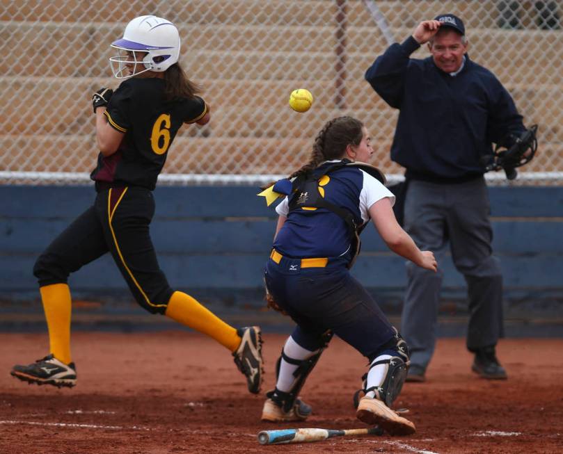 Pahrump’s Amaya Mendoza (6) scores a run as Boulder City’s Marleena Mills (6) mi ...