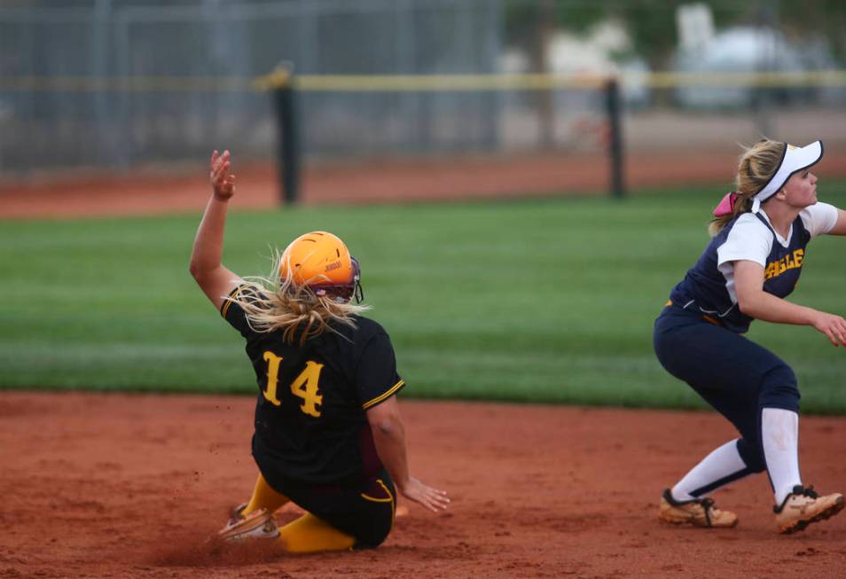 Pahrump’s Jordan Egan (14) slides into second base against Boulder City’s Micayl ...