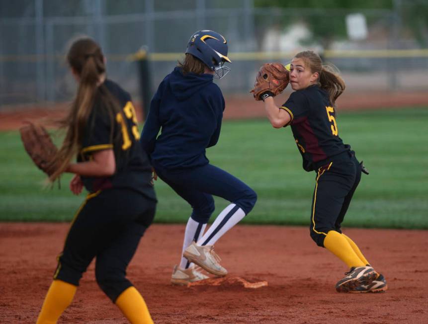 Pahrump’s Skyler Lauver (5) looks to throw after tagging out Boulder City’s Raeg ...