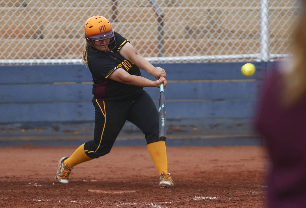 Pahrump’s Jordan Egan (14) hits the ball during a softball game at Boulder City High S ...