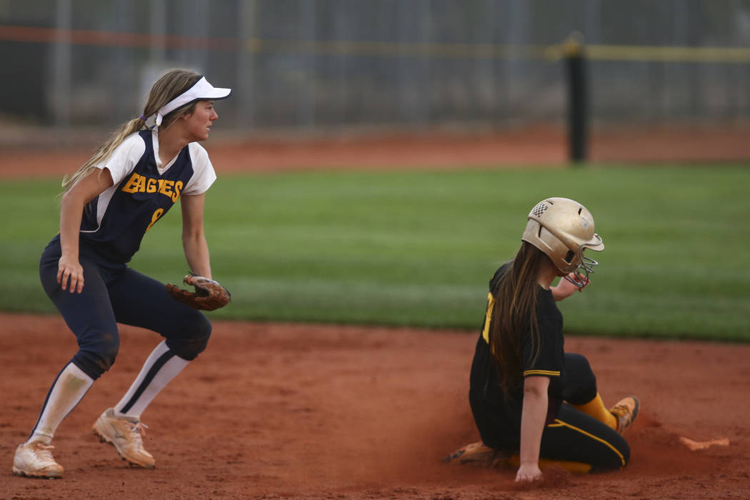 Pahrump’s Jackie Stobbe (13) slides into second base past Boulder City’s Ashley ...