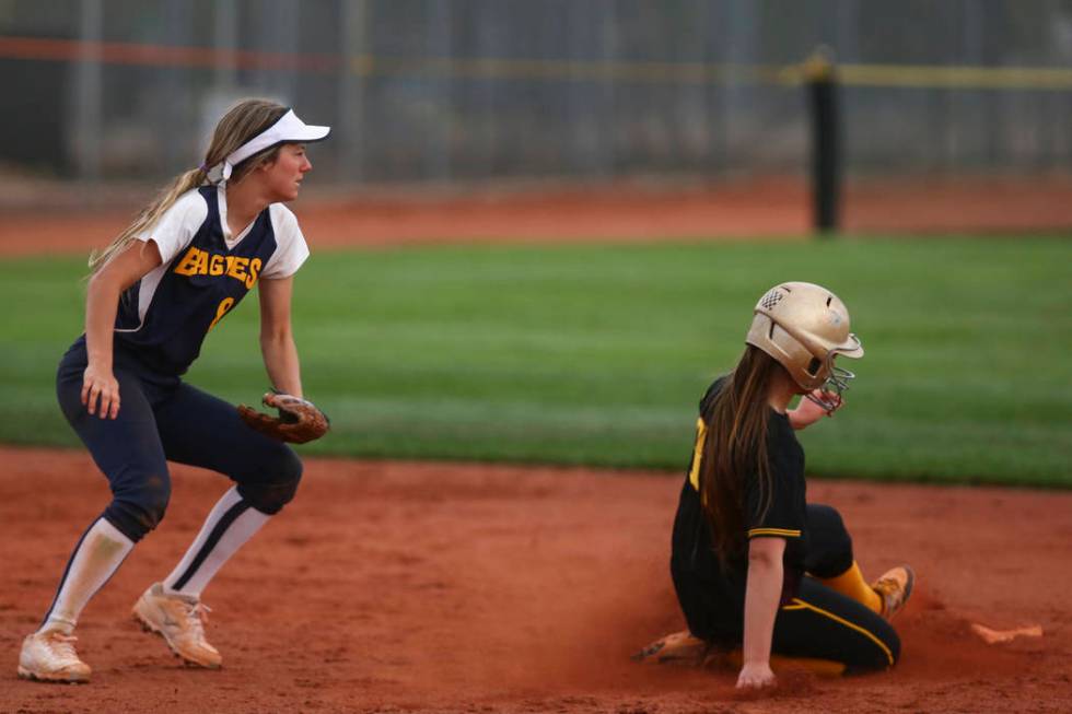 Pahrump’s Jackie Stobbe (13) slides into second base past Boulder City’s Ashley ...