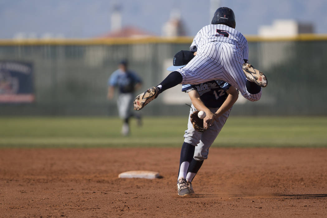 Coronado’s John Cascardo (5) leaps over Foothill’s Chase Parenteau before gettin ...