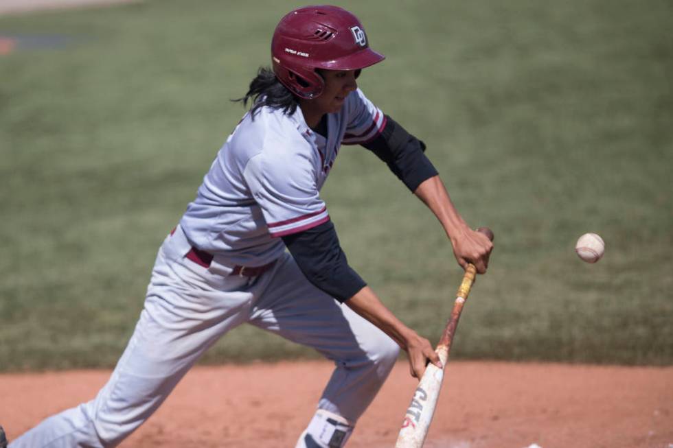 Desert Oasis Andrew Martinez (2) bunts the ball for a single against Bishop Gorman at Bishop ...