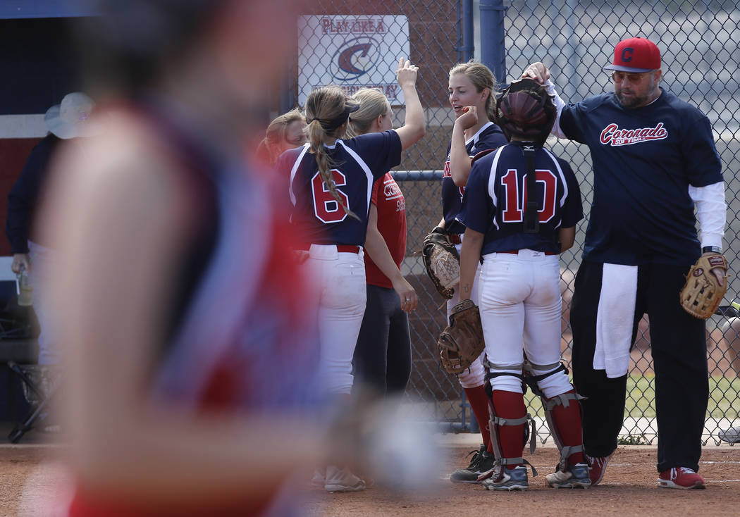 Coronado players huddle during the third inning of a high school softball game at Coronado H ...