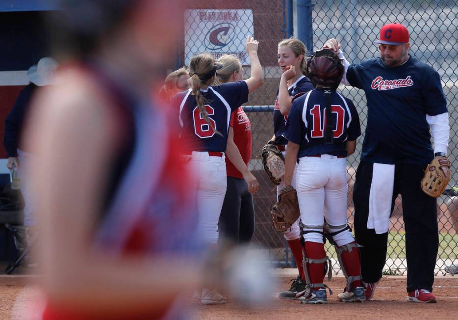 Coronado players huddle during the third inning of a high school softball game at Coronado H ...