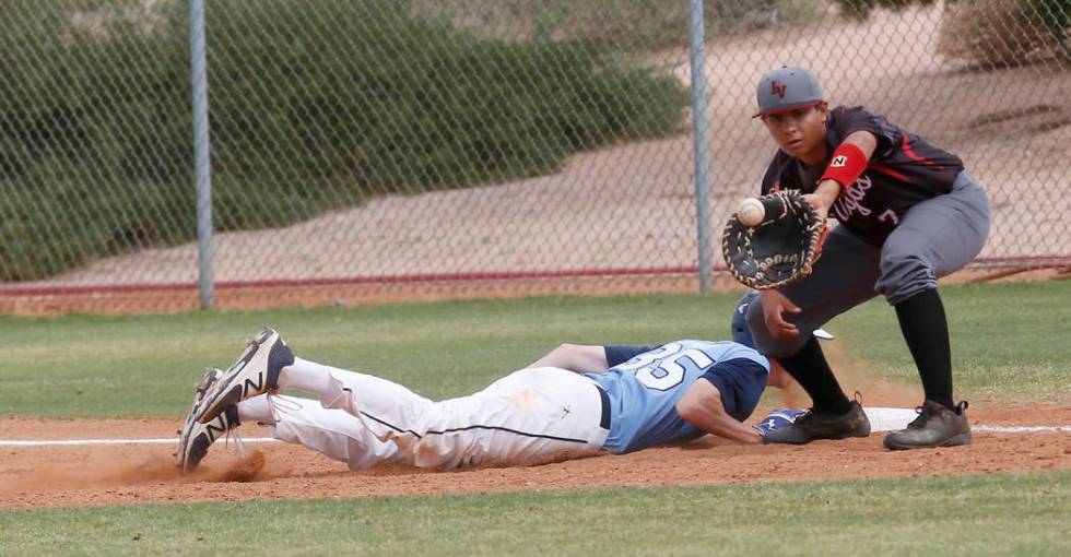 Foothill’s Gage Streit (35) dives for first base as Las Vegas’s Payton Miller (7 ...