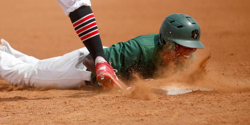 Palo Verde’s Wesley Cosby (6) dives for first base after leading off of it during the ...