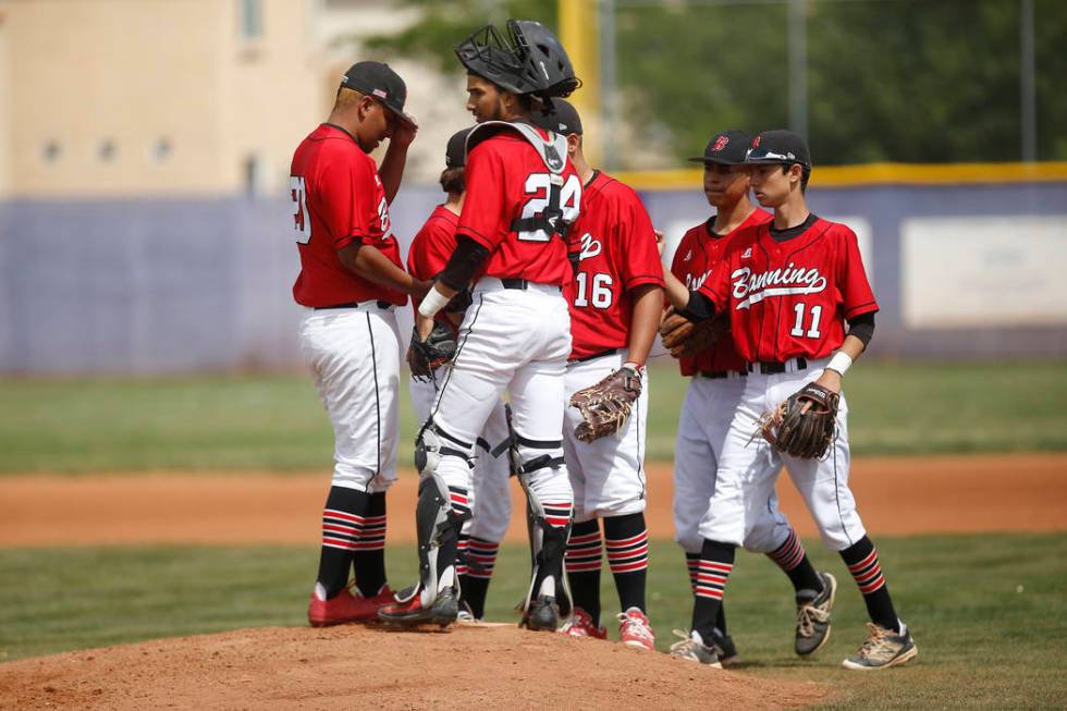 Banning players gather on the mound during the first inning of a high school baseball game a ...