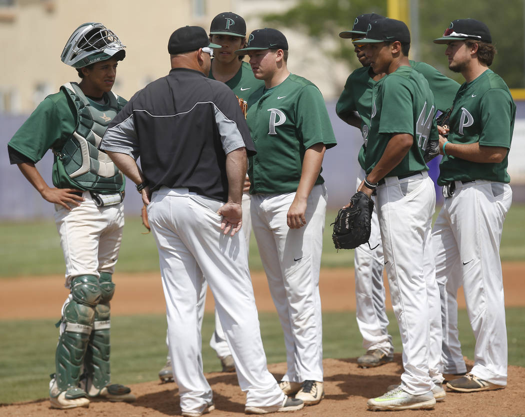 Palo Verde players gather at the mound during the second inning of a high school baseball ga ...