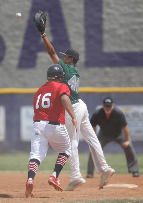 Banning’s Gabriel Gonzalez (16) is safe at first base as Palo Verde’s Jaret Godm ...