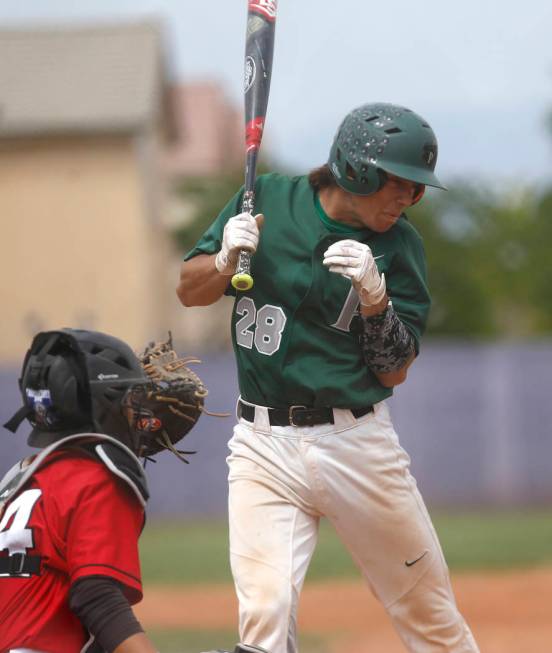 Palo Verde’s Chandler Kochan (28) reacts after being hit by a pitch during the seventh ...