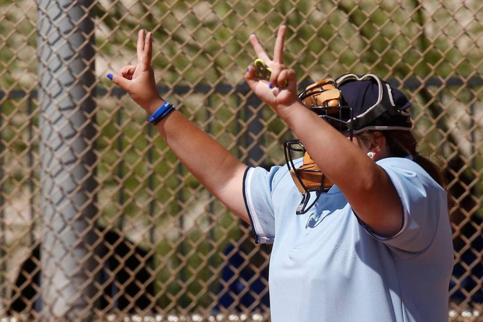 An umpire signals the pitch count during a high school softball game at Majestic Park on Thu ...