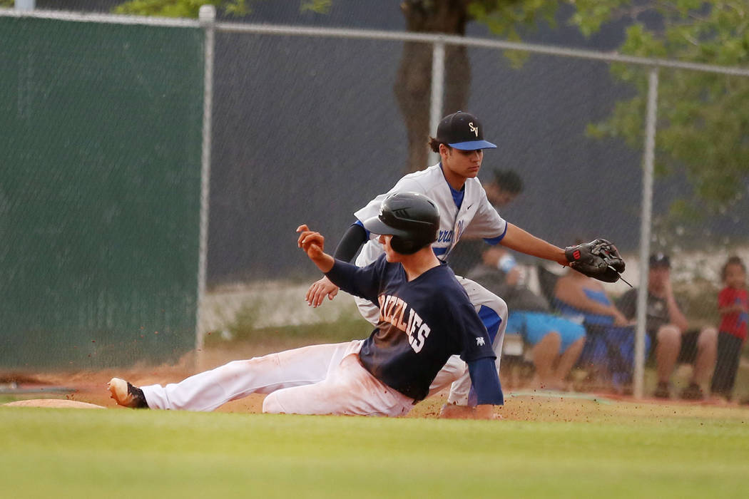 Spring Valley’s Bryce Bullock is safe at third base against Sierra Vista High School a ...