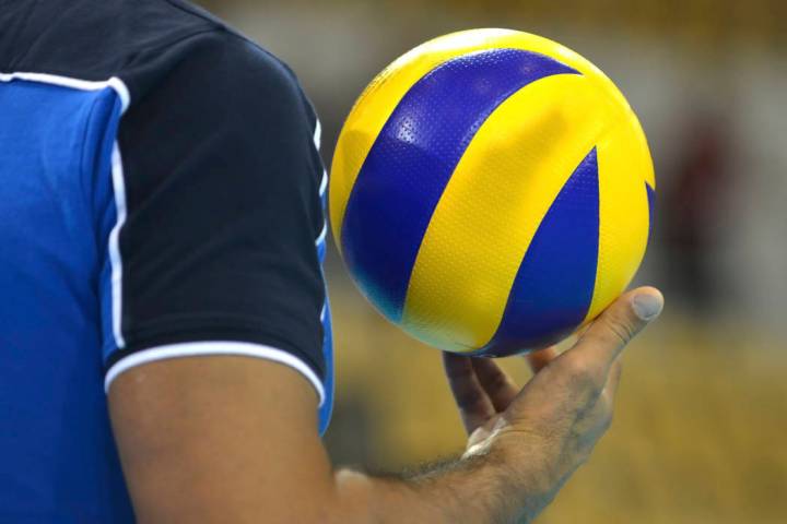 Volleyballplayer with a volleyball in his right hand