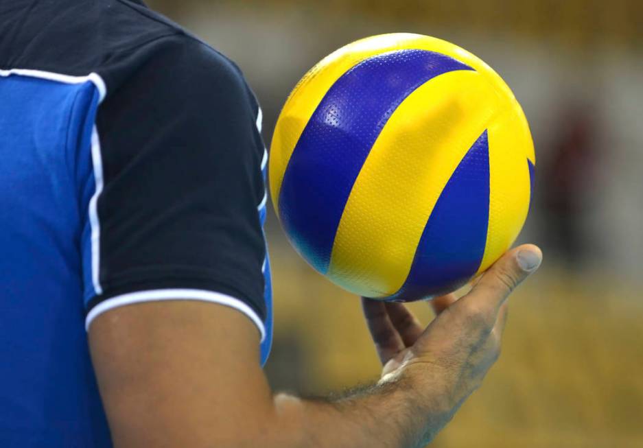 Volleyballplayer with a volleyball in his right hand