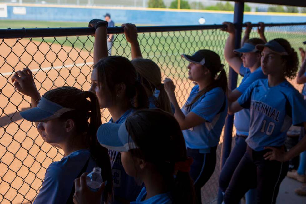 Centennial teammates watch the first inning from the dugout during a game against Shadow Rid ...